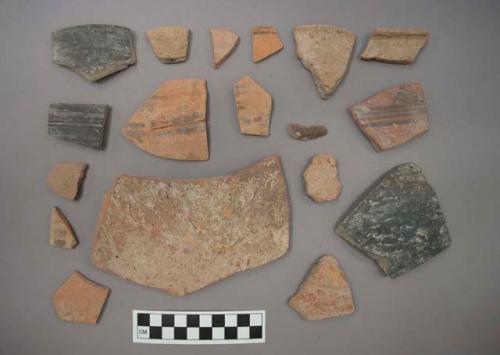 Ceramic rim or body sherds and one stone flake?, some sherds with painted or incised designs