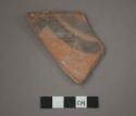 Ceramic rim sherd of bowl, black painted designs on red on interior