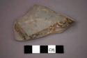 Ceramic base sherd, dark painted design on gray on interior