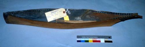 Wooden canoe model with 4 paddles. Bead decoration