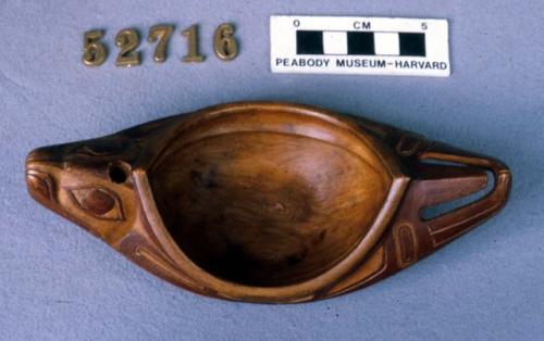 Carved maple cup, with zoomorphic heads at both ends. Red pigment.