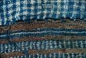 Blue and white plaid textile with brown, blue and white border from Site 19