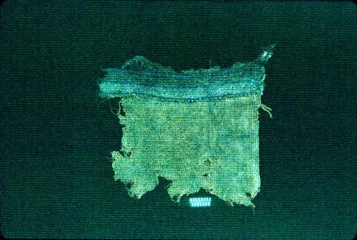 Brown textile fragment with thin blue lines from Site 31