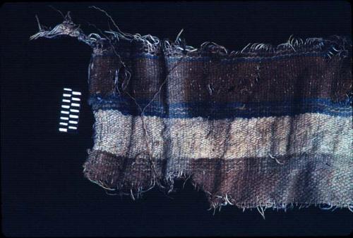 Textile with brown, white and blue stripes from Site 60