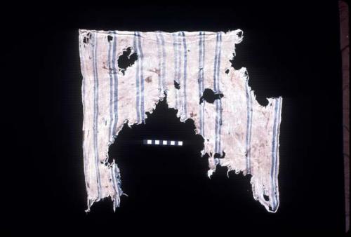 White textile fragment with blue stripes from Site 19