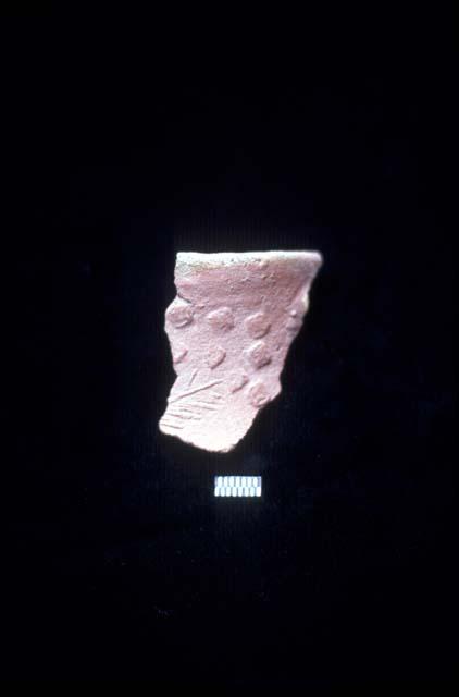 Press molded ceramic sherd with green glaze from Site 128