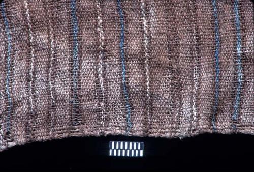 Textile fragment with thin white and blue stripes on brown from Site 120