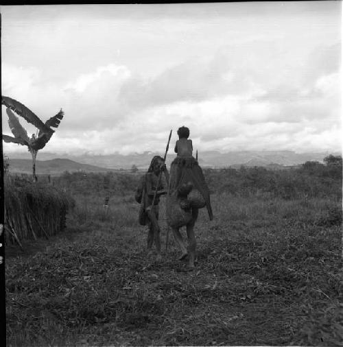 Aneakhe and woman pass on path