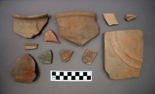 Ceramic sherds, including a partial vessel cup?, some sherds are painted or have painted designs