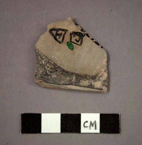 Ceramic body sherd, black painted designs on buff on interior and exterior