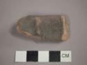 Pottery ladle handle fragment --baby in cradle?