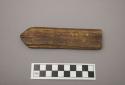 Wood fragment, worked, pointed end, grooved both sides