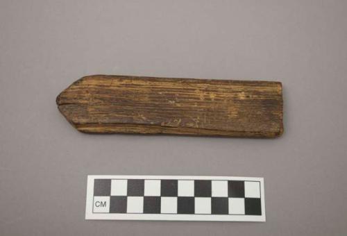 Wood fragment, worked, pointed end, grooved both sides