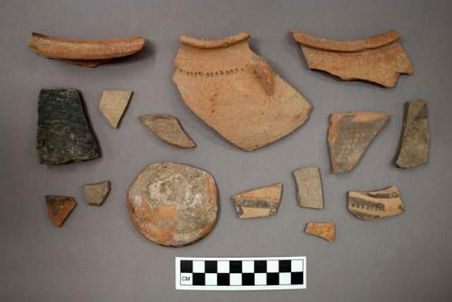 Ceramic sherds, some sherds have painted designs, one sherd has incised designs and a perforated lug, one sherd is burnished