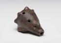 Black Ware four hole ocarina representing conch shell, incised and with punctuation