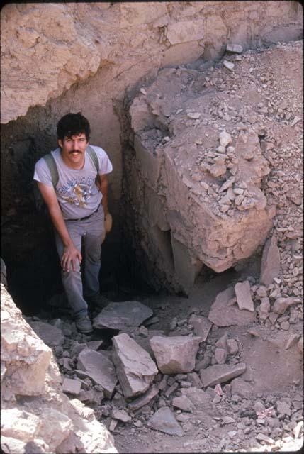 Man standing inside structure at Site 128