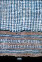 Blue and white plaid textile with brown, blue and white border from Site 19