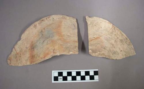 Fragments of undecorated pottery plate