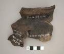 Miscellaneous unglazed body sherds with incised or impressed designs.