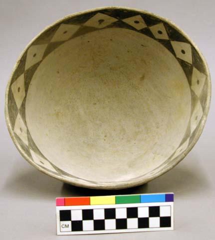 Ceramic bowl, black on white interior design.