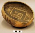 Ceramic bowl, shallow, irregular shape, brown on buff geometric and linear