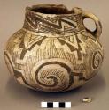 Jar, rim sherds missing, black on white geometric design on exterior, single lug