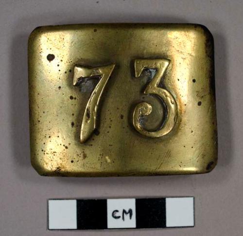 Belt buckle with number "73" on the front