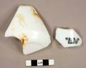 Opaque white glass fragments, one from a jar and one from a dish; dish fragments with applied decoration, one reads: "LUCY ARMSTRONG"