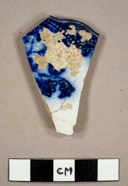 Flow blue plate rim sherd with scalloped edge