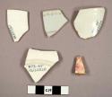 Whiteware, ironstone, and European porcelain sherds, including rim sherds to cups and plates and possible saucer base sherd; one sherd with red transfer pritn, one sherd with blue and red decoration, and one sherd with "SINGANESE / J. WEDGWOOD." on base