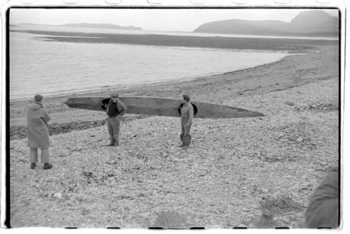 Men holding kayak