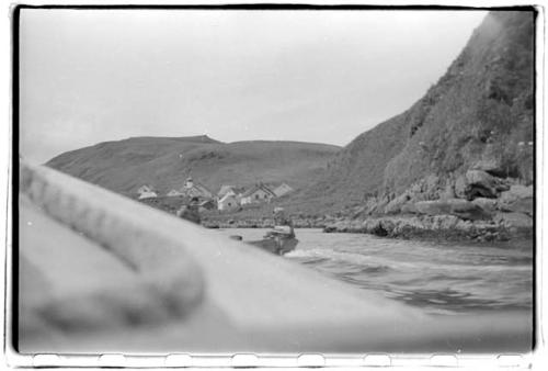 View from boat of coast and village