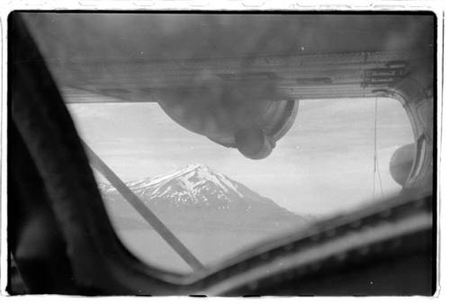 Mountain through airplane window