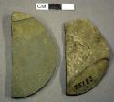 Ground stone, disc fragments, semi-lunar shaped, pitted middle