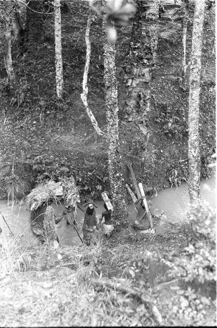 Women and children crossing river