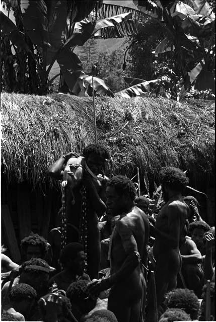 Men holding up offerings