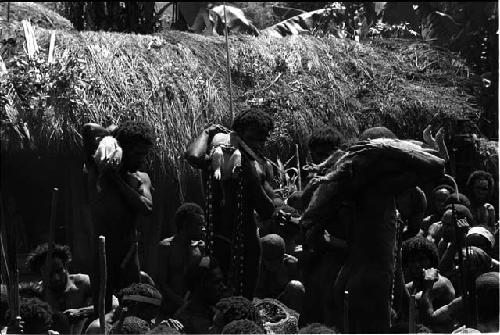 Men holding up offerings