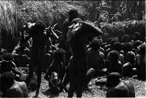 Men holding up offerings