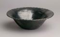 Pottery bowl. Rim recurved and flaring with fluted edge, polished black ware.