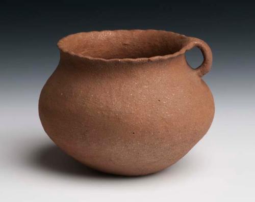 Pottery cooking vessel. Globular with slightly outcurved fluted rim, handle