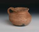 Pottery cooking vessel. Globular with outcurving rim, small handle, brown ware