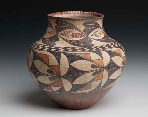 Pottery olla. Globular, irreglar with incising along neck rim. Designs of crea