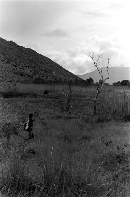 Boy shoots arrow at enemy