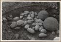 Photographs of S. K. Lothrop's trip through Costa Rica, 1948 - 1950.  Stone sphere, excavation.  Palmar.  Farm 4, Sec. 23, Pit e.  Stone platform and balls C and D (right) in situ