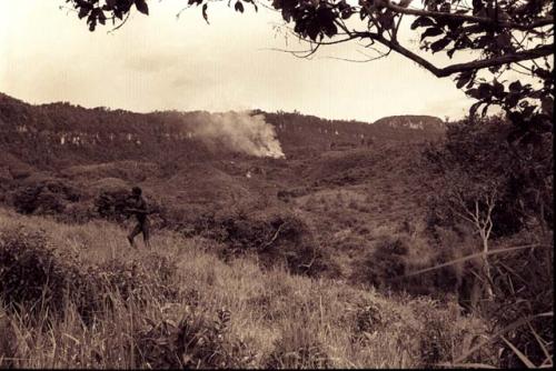 Photograph of Field with smoke in distance