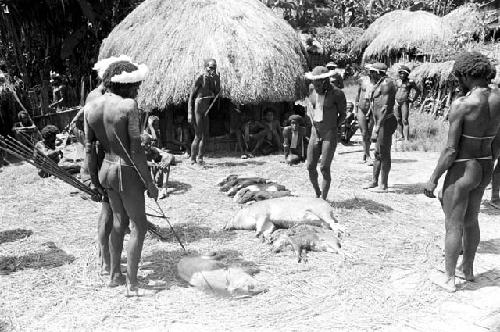 Wali with his bow and arrows and other men watching