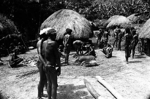 Wali with his bow and arrows and other men watching