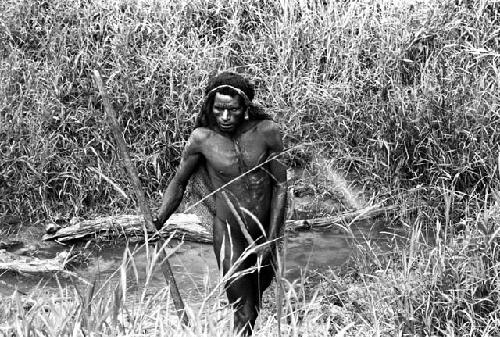 a person working in the grass with a long pole