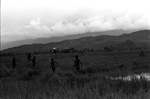 men standing up running towards the Warabara