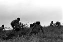 warriors crouching trying to stay hidden while working their way up to the top of the knoll of the Warabara